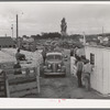 Lineup of cars with trailers waiting for their times to list stock for sale at the auction. Ontario, Oregon