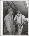Sheep shearers on ranch in Malheur County, Oregon. The cord around the waist of man on right is used to sew up the sacks which contain wool. These sheep shearers travel in outfit of which man on left is boss, has about twenty members