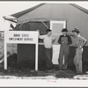 Idaho state employment representative (left) talking to farm workers who live at the FSA (Farm Security Administration) migratory labor camp mobile unit. Wilder, Idaho. The state employment service has offices at most FSA camps