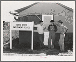 Idaho state employment representative (left) talking to farm workers who live at the FSA (Farm Security Administration) migratory labor camp mobile unit. Wilder, Idaho. The state employment service has offices at most FSA camps