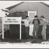 Idaho state employment representative (left) talking to farm workers who live at the FSA (Farm Security Administration) migratory labor camp mobile unit. Wilder, Idaho. The state employment service has offices at most FSA camps