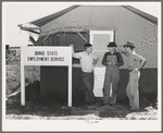 Idaho state employment representative (left) talking to farm workers who live at the FSA (Farm Security Administration) migratory labor camp mobile unit. Wilder, Idaho. The state employment service has offices at most FSA camps