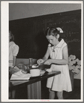 Schoolgirl demonstrating cooking methods at the 4-H Club Spring fair. Adrian, Oregon