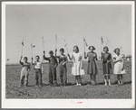 Flag drill for entertainment at end of school term at the FSA (Farm Security Administration) camp for farm workers. Caldwell, Idaho