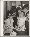 Schoolchildren and their mothers looking at handwork at the 4-H Club Spring fair. Adrian, Oregon