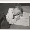 Schoolgirl at the FSA (Farm Security Administration) farm workers' camp. Caldwell, Idaho. Several family units of the row shelters have been thrown open to form a big room for the school
