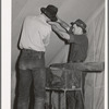 Farm workers fixing up the tent in which they will live at the FSA (Farm Security Administration) migratory labor camp mobile unit. Wilder, Idaho