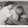 Doctor and nurse at the FSA (Farm Security Administration) migratory labor camp mobile unit. Wilder, Idaho. Doctor visits the trailer-clinic twice a week