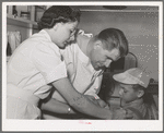 Doctor and nurse at the FSA (Farm Security Administration) migratory labor camp mobile unit. Wilder, Idaho. Doctor visits the trailer-clinic twice a week