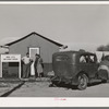 Newly-arrived farm workers talking to the Idaho state employment representative at the FSA (Farm Security Administration) migratory labor camp mobile unit. Wilder, Idaho