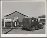 Newly-arrived farm workers talking to the Idaho state employment representative at the FSA (Farm Security Administration) migratory labor camp mobile unit. Wilder, Idaho