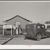 Newly-arrived farm workers talking to the Idaho state employment representative at the FSA (Farm Security Administration) migratory labor camp mobile unit. Wilder, Idaho