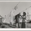 Hanging out the wash at the FSA (Farm Security Administration) migratory labor camp mobile unit. Wilder, Idaho