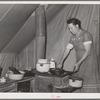 Farm worker's wife prepares dinner. FSA (Farm Security Administration) migratory labor camp mobile unit. Wilder, Idaho