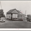 Old house being moved to make room for expansion of Arden Farms Creamery. San Diego, California