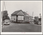 Old house being moved to make room for expansion of Arden Farms Creamery. San Diego, California