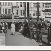 Sailors lined up against chain-rail in square in midtown. San Diego, California