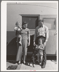 Family outside their trailer home at the FSA (Farm Security Administration) camp for defense workers. San Diego, California