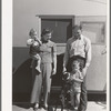 Family outside their trailer home at the FSA (Farm Security Administration) camp for defense workers. San Diego, California
