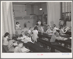 Second and third grades at the Balboa School, San Diego, attend classes held in the cafeteria of the school. San Diego, California