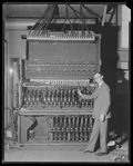 Unidentified man with lighting switches and dimmers, backstage at the production Spring and Autumn