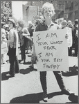 Donna Gottschalk holds "I am your worst fear I am your best fantasy" poster at Christopher Street Gay Liberation Day parade, 1970