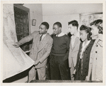 Lawrence D. Reddick discussing a map of Africa with four visiting City College of New York students