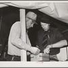 Camp manager, right, and engineer, left, check electrical connection. Mobil unit, FSA (Farm Security Administration) labor camp. Nampa, Idaho