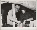 Camp manager, right, and engineer, left, check electrical connection. Mobil unit, FSA (Farm Security Administration) labor camp. Nampa, Idaho