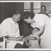 Doctor and nurse give daughter of farm worker tick fever serum at the FSA (Farm Security Administration) labor camp. Caldwell, Idaho