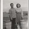 This boy and girl were the champion pea pickers in the contractor's camp. They travel with their families in the contractor's camps. They have picked as many as thirty-two hampers each a day. Pay thirty cents per hamper. It is normal to pick about twenty