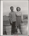 This boy and girl were the champion pea pickers in the contractor's camp. They travel with their families in the contractor's camps. They have picked as many as thirty-two hampers each a day. Pay thirty cents per hamper. It is normal to pick about twenty