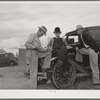 Pea pickers talking in camp. Canyon County, Idaho