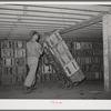 Crates of lettuce being wheeled to refrigerator cars for shipment. Canyon County, Idaho