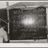 Bulletin board in labor contractor's camp (pea pickers). Canyon County, Idaho