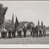 Members of the American Legion and Boy Scouts stand at attention while Chief Justice Stone delivered the oath of allegiance over the radio. This was part of the nationwide program on the Fourth of July and in Vale, Oregon, the baseball game was