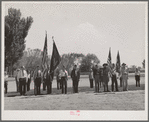 Members of the American Legion and Boy Scouts stand at attention while Chief Justice Stone delivered the oath of allegiance over the radio. This was part of the nationwide program on the Fourth of July and in Vale, Oregon, the baseball game was