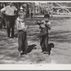 The boy who caught the greased pig at the Fourth of July celebration at Vale, Oregon. The little boy who caught the pig says he's going to join the 4-H Club so he can learn how to feed his pig properly
