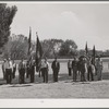 Members of the American Legion and Boy Scouts stand at attention while Chief Justice Stone delivered the oath of allegiance over the radio. This was part of the nationwide program on the Fourth of July and in Vale, Oregon, the baseball game was