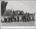 Members of the American Legion and Boy Scouts stand at attention while Chief Justice Stone delivered the oath of allegiance over the radio. This was part of the nationwide program on the Fourth of July and in Vale, Oregon, the baseball game was