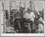 Farm boys getting on the ferris wheel, one of the attractions at the Fourth of July celebration at Vale, Oregon