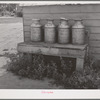 Milk cans on farm of member of the Dairymen's Cooperative Creamery. Caldwell, Canyon County, Idaho. The slogan of the co-op has been "Every Member a Fieldman"