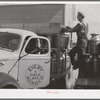 Collecting cans of milk and cream at farm of member of the Dairymen's Cooperative Creamery. Caldwell, Canyon County, Idaho