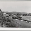 Scene in Garden Valley, Boise County, Idaho. The valley is lush and green, spotted with small farms and the many hay fields indicate the importance of dairying