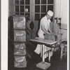 Lining tub with oiled paper before packing butter into it. Dairymen's Cooperative Creamery. Caldwell, Canyon County, Idaho