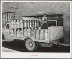 Truckload of milk-filled cans arrive at the Dairymen's Cooperative Creamery. Caldwell, Canyon County, Idaho