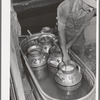 Member of the Dairymen's Cooperative Creamery cooling fresh milk in water trough on his farm. Caldwell, Canyon County, Idaho
