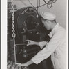 Recording weight, etc. of samples of cream and milk at Dairymen's Cooperative Creamery. Caldwell, Canyon County, Idaho