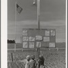 Children at the farm activities bulletin board at the FSA (Farm Security Administration) migratory farm labor camp mobile unit. Athena, Oregon