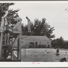Children from the FSA (Farm Security Administration) migratory farm labor camp mobile unit swim in the town swimming pool of Athena, Oregon